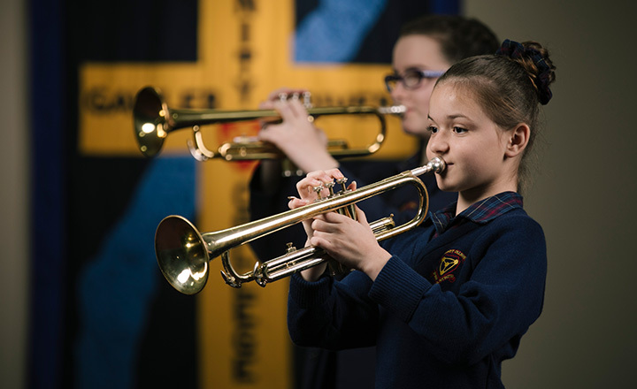 Trinity College junior student class playing the trumpet