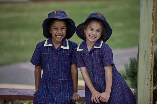 Two Trinity Junior School Students with hats