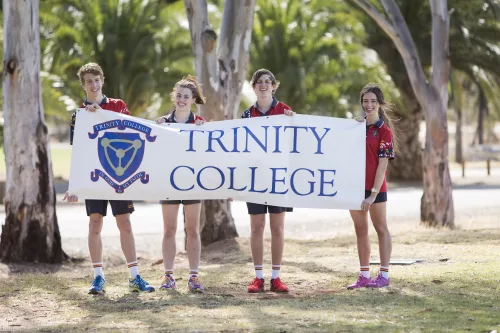 Students holding Trinity College banner
