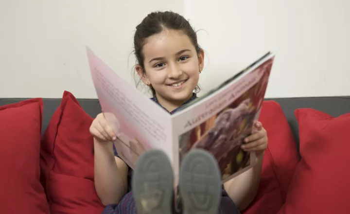 Trinity Junior school student happily reading.