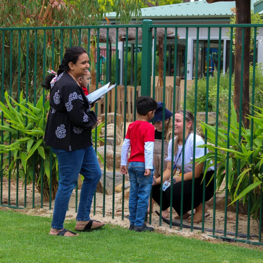 Talking through the fence with teacher.