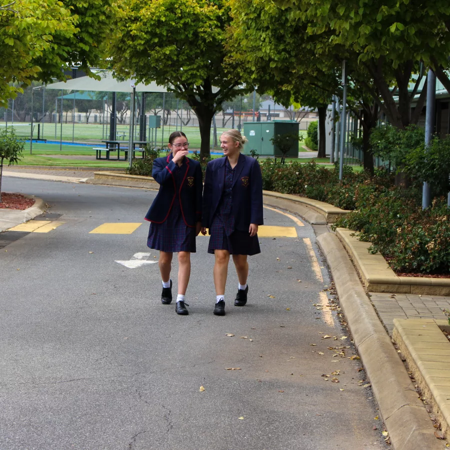 Two new students walking and talking at Trinity College Welcome Event